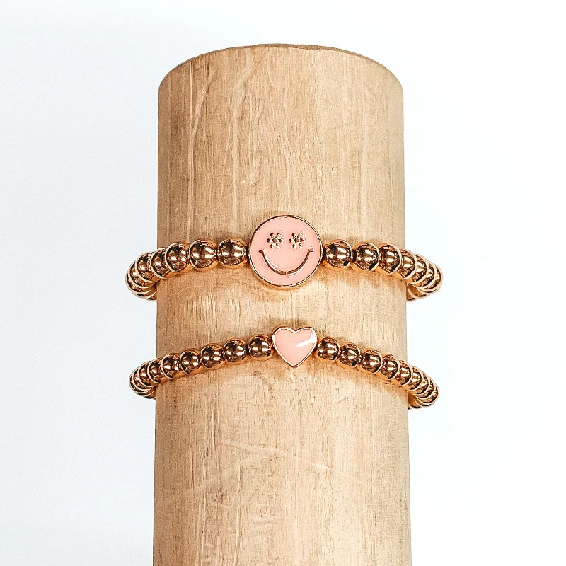 women’s gold chain bracelets-Set of Two | Gold Beaded Bracelets with Heart and Happy Face Pendant in Baby Pink